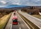 Red buses in line traveling on a highway