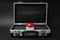 Red button of nuclear weapon in suitcase on black background. War concept