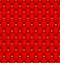 Red button-tufted velvet background.