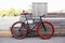 Red bycicle parked near bench in park