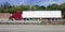 Red cab semi with white trailer on interstate