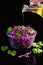 Red cabbage salad with parsley, glass bowl, organic food, olive oil pouring from the bottle