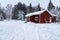 Red cabin covered in snow in sweden