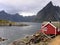 Red cabin on fjord in Norway