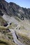 Red cable car over alpine road in Fagaras