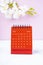 The Red calendar August 2023. Desk calendar for year 2023 and pink orchid on pink background