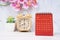 The Red calendar July 2023. Desk calendar for year 2023 and pink orchid on wooden background