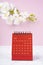 The Red calendar June 2023. Desk calendar for year 2023 and pink orchid on pink background