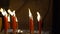 A red candle with a fire bearing a Chinese text written as good luck while receiving Chinese New Year