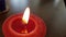 Red candle with flame closeup and copy space