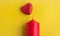 Red candle red hearts symbol on yellow background