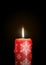 Red Candle with Starlet Texture on Black Background - Isolated C