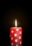 Red Candle with Starlet Texture on Black Background - Isolated C