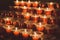 Red candles in the church. Row of glowing candles. Candlelight in the night. Christmas holiday background.