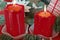 Red candles with flame, part of Christmas decoration. Good light, red color, Christmas time