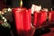 Red candles with flame, part of Christmas decoration. Good light, red color, Christmas time