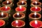 Red candles in rows glowing in the dark.