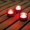 Red candles on warm wood background