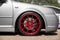 Red candy colored light alloy wheels on silver hatchback