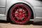 Red candy colored light alloy wheels on silver hatchback