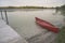 Red Canoe Beached On Lake