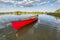 Red canoe on a calm lake