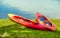Red canoe lying in the grass