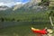 Red canoe moored on the bank