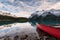 Red canoe parked on Maligne lake with Canadian rockies reflection in Spirit island at Jasper national park