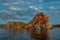 Red cape Shamanka rock in blue Lake Baikal, clouds, sunset, reflection, ripples