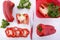 Red capsicum peppers on white wood table.