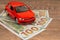 Red car with 100 dollars banknotes, expencive auto service or repair