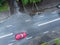 Red car crossing a flooded street after rain. aerial view