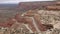 Red car driving down Moki Dugway