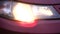 Red car headlight turning on and off. Close-up of details of headlights