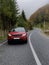 Red car, land rover driving on the road Carpathians Ukraine. Discovery