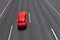 Red car moves fast on highway.