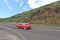 A red car on one of the Hawaiian highways