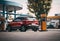 a red car is parked at the gas station with gas