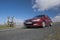 Red car speeding on mountain road in Devon