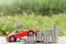 Red car on stack of coin on blurred green natural background. Saving money and investment concept
