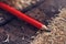 Red carpenter pencil on desk in workshop