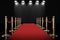 Red carpet and rope barrier with shining spotlights