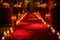 red carpet surrounded by lit candles, creating warm and welcoming setting