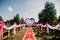 Red carpet wedding arch and chairs for ceremony decorated