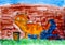 Red cat painting brick wall by his tail. Child watercolour hand
