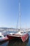 Red catamaran yacht moored in marina