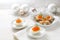 Red caviar on halved eggs and star shaped canapes, white table with light Christmas decoration for a festive holiday buffet, copy