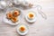 Red caviar on halved eggs and on star shaped canapes, white wooden table with Christmas decoration for a festive holiday buffet,