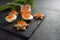 Red caviar on halved eggs and on toasted canapes in star shape with dill, preparation for a festive Christmas buffet on a dark